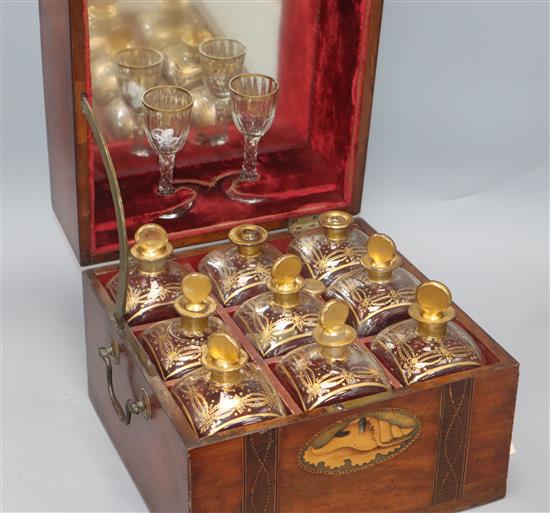 A 19th century inlaid liqueur casket with gilded bottles and glasses